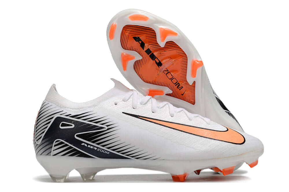 Chuteira Nike Air Zoom Mercurial Vapor 16 Elite FG - Branco, Preta e Laranja em ângulo com sola visível.