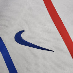 Camisola Holanda Away 12/13 Retro com detalhes em azul e vermelho e logotipo da Nike destacado.