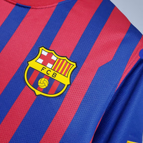 Camisa Barcelona Home 11/12 Retro com escudo colorido e listras vermelhas e azuis.
