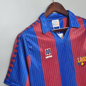 Camisa Barcelona Home 90/91 retro, com design listrado vermelho e azul, disponível na loja olímpica.