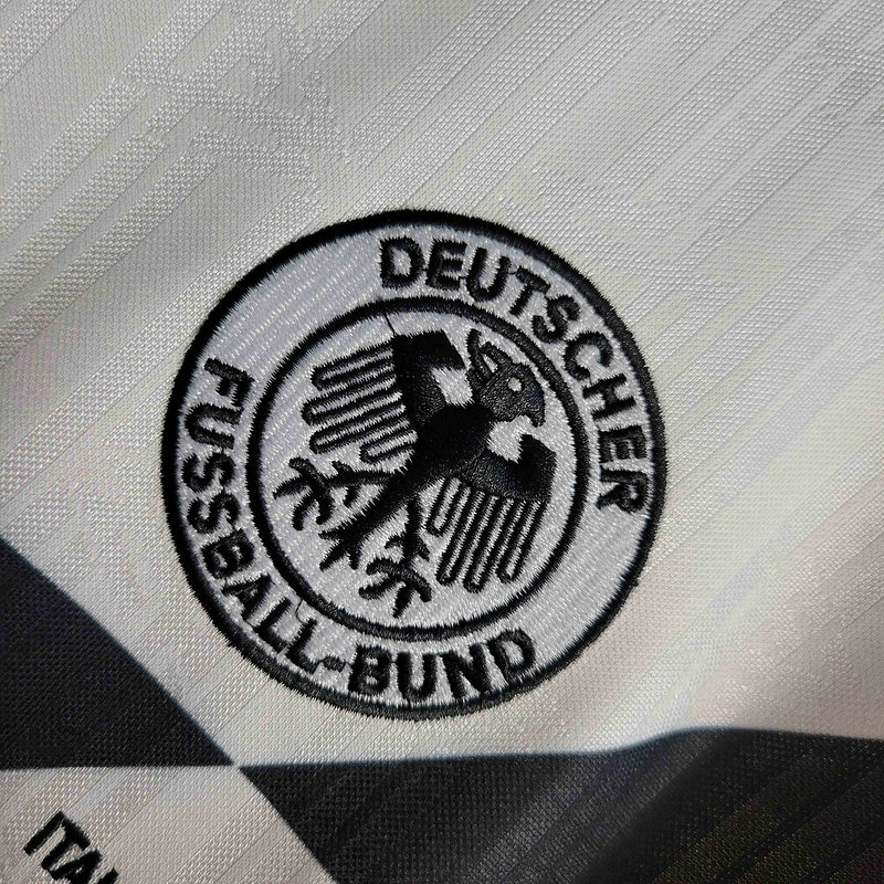 Emblema da Camisola Alemanha home 1990 Retro, representando o Deutscher Fußball-Bund.