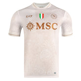 Camisola Napoles alternativo branca 2025/26 com detalhes em dourado e logo do Napoli.
