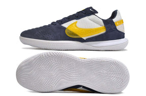 Chuteira Futsal Nike Street Gato IC - Branca, Azul e Amarela com sola IC para futsal e design moderno.