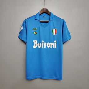 Camisolas Napoli Home 87/88 Retro, camisola de futebol azul com logo Buitoni e escudo da Itália.